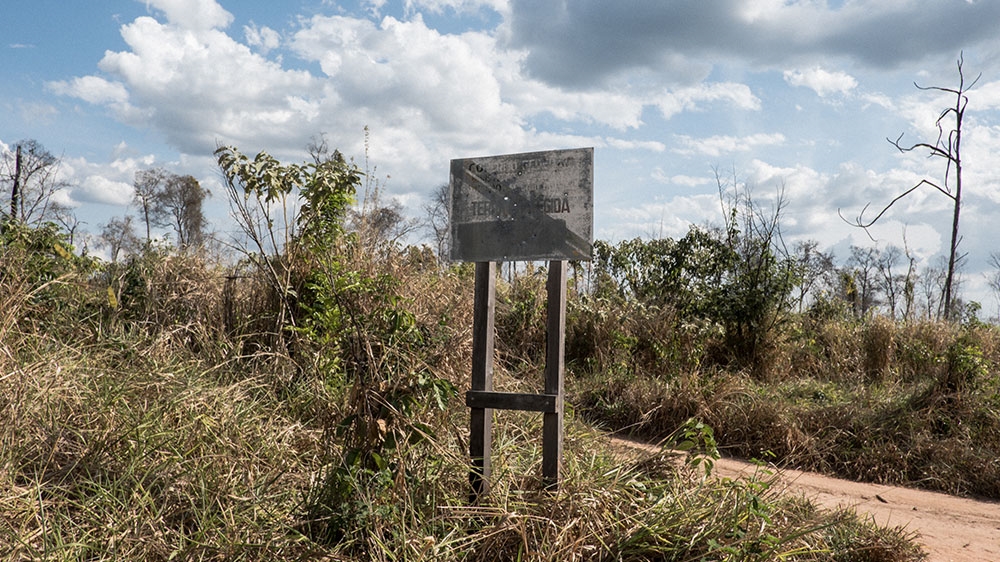 A sign marking an indigenous territory is riddled with bullet holes [Tommaso Protti/Al Jazeera]