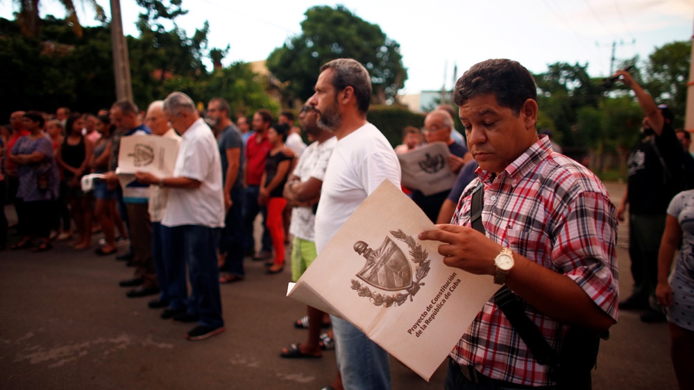 Cubans read the draft proposal of changes to the constitution during the beginning of a public political discussion to revamp a Cold War-era constitution in Havana, Cuba [Tomas Bravo/Reuters]