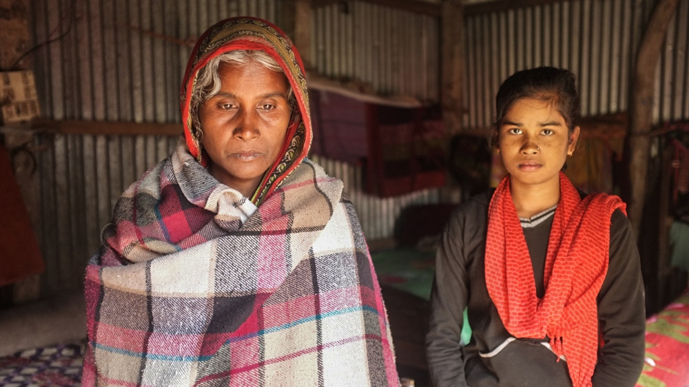 With both her sons, Omor Ali and Shirapat Ali, trapped in the mine, Omela Bibi (left) says there is no man left in the household [Priyanka Borpujari/Al Jazeera]