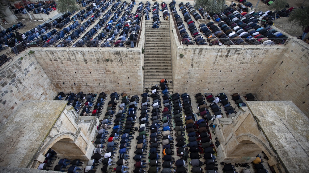 Palestinians perform Friday prayer outside Bab al-Rahma in the Al-Aqsa Mosque compound on February 22 [Faiz Abu Rmeleh/Anadolu Agency]