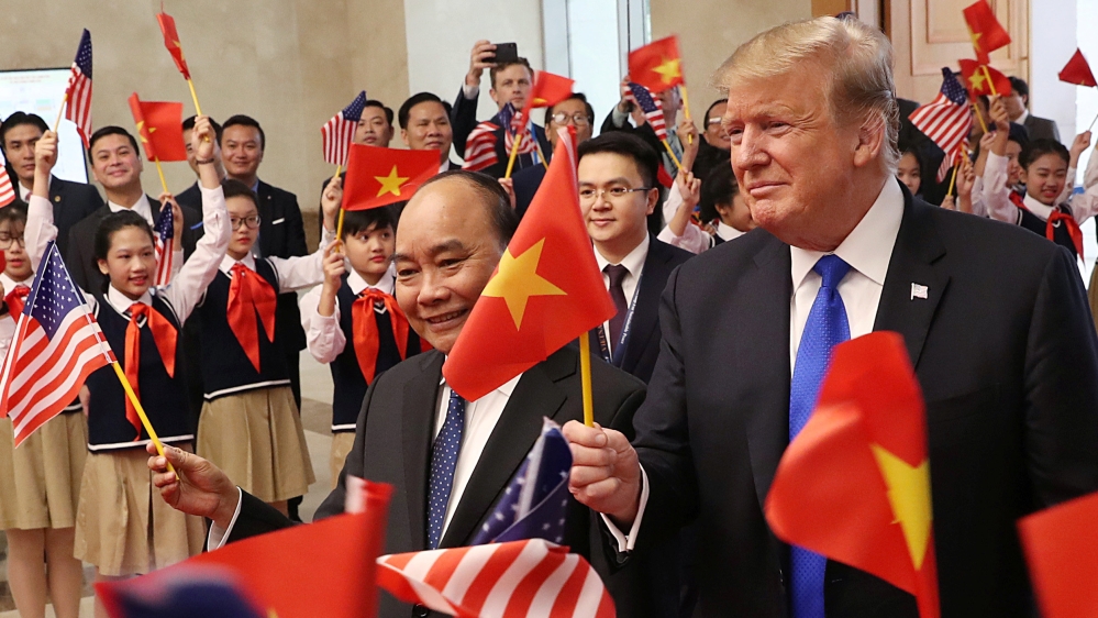 Trump and Nguyen Xuan Phuc greeted by students [Leah Millis/Reuters]