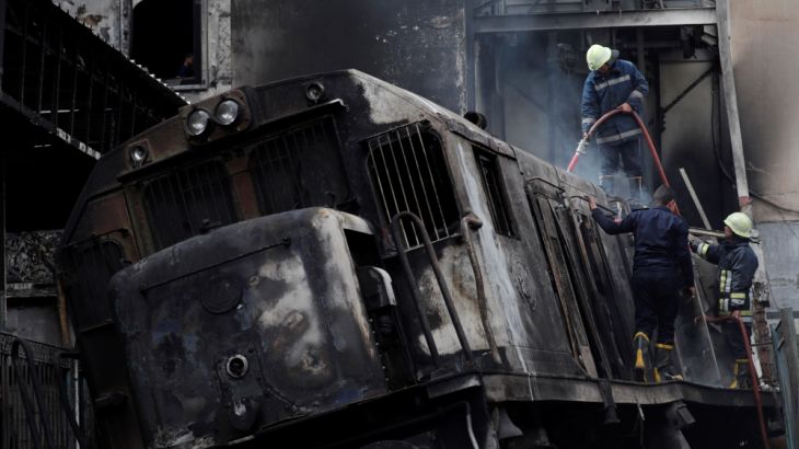 Rescue workers put out a fire at the main train station in Cairo