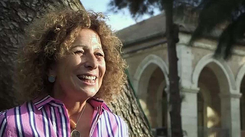 Actress and tour guide Huda Imam wanders through the streets of Jerusalem [Al Jazeera]