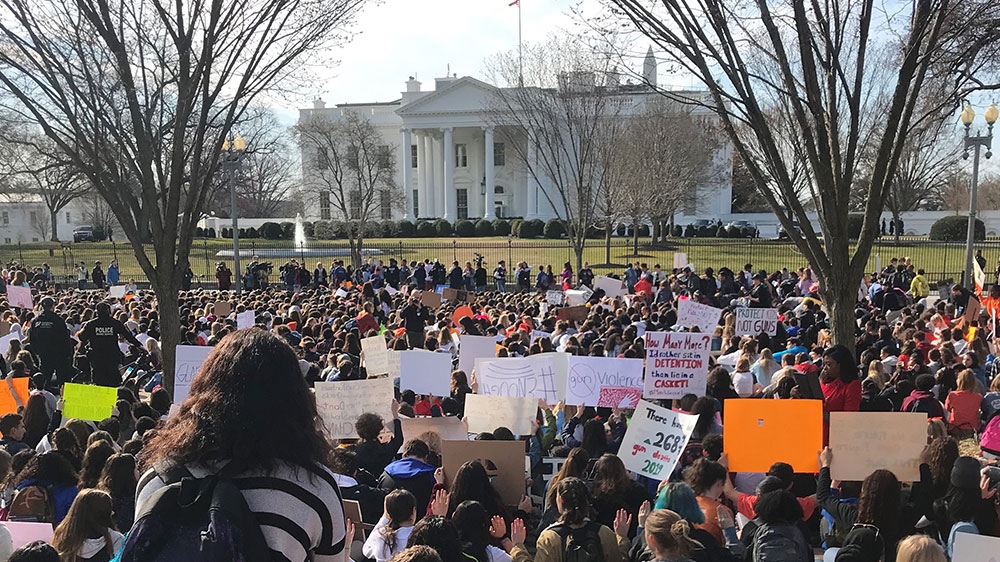 Students observe 17 minutes of silence outside the White House in honour of the 17 lives lost in the Parkland shooting last year [Ola Salem/Al Jazeera]