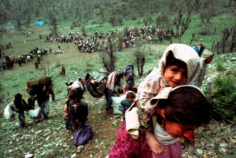 Kurdish refugees flee close to the Iraqi-Turkish border, April 20, 1992. REUTERS/Yannis Behrakis/File photo SEARCH "YANNIS BEHRAKIS" FOR THIS STORY. SEARCH "WIDER IMAGE" FOR ALL STORIES.