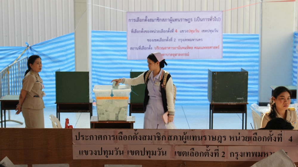 A nurse votes at a Bangkok polling station in Sunday's election. [Kate Mayberry/Al Jazeera]