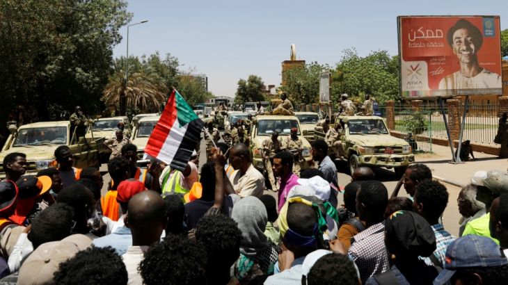 Sudanese demonstrators chant slogan in front of security forces during a protest in Khartoum, Sudan April 15, 2019