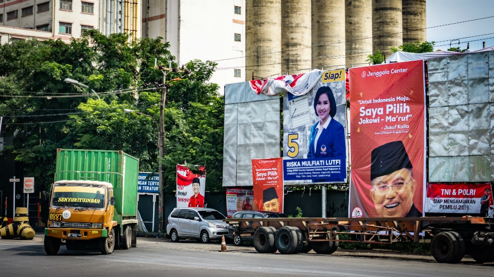 A poster of incumbent Vice President and Sulawesi native Jusuf Kalla outside a new port that's under construction in Makassar. Having been in office for two terms, Kalla cannot run against but is backing Widodo [Ian Morse/Al Jazeera] 