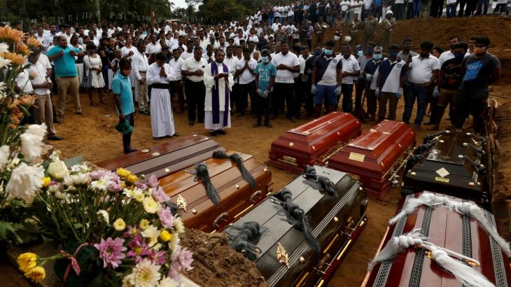 FILE PHOTO: People participate in a mass funeral in Negombo