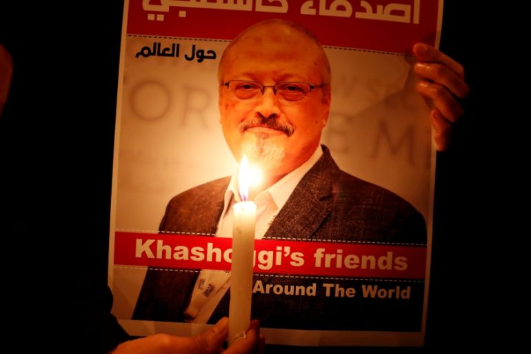 A demonstrator holds a poster with a picture of Saudi journalist Jamal Khashoggi outside the Saudi Arabia consulate in Istanbul
