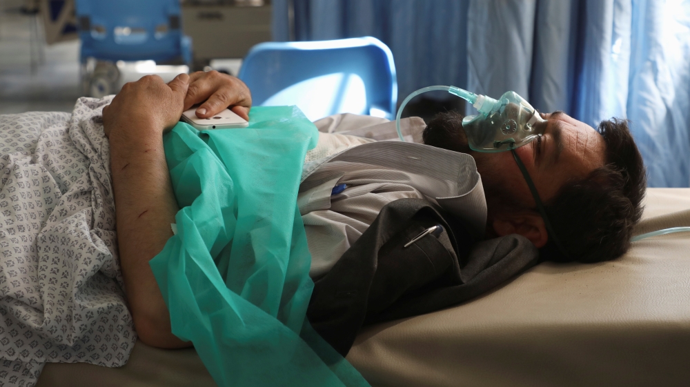A wounded man receives treatment at a hospital after a blast in Kabul, Afghanistan