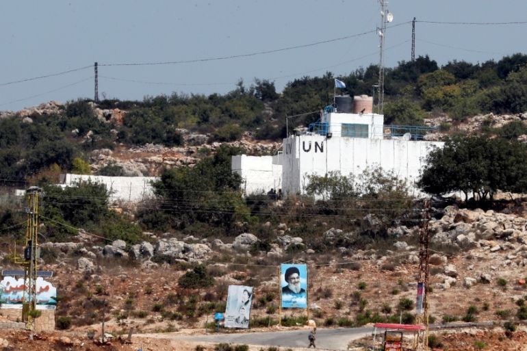 A banner depicting Hezbollah leader Sayyed Hassan Nasrallah and an United Nation''s post are seen in Lebanon from the Israeli side of the border, near Zar''it in northern Israel