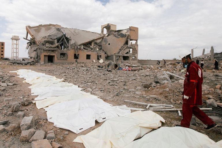 A Red Crescent medic walks next to bags containing the bodies of victims of Saudi-led airstrikes on a Houthi detention centre in Dhamar, Yemen, September 1, 2019. REUTERS/Mohamed al-Sayaghi