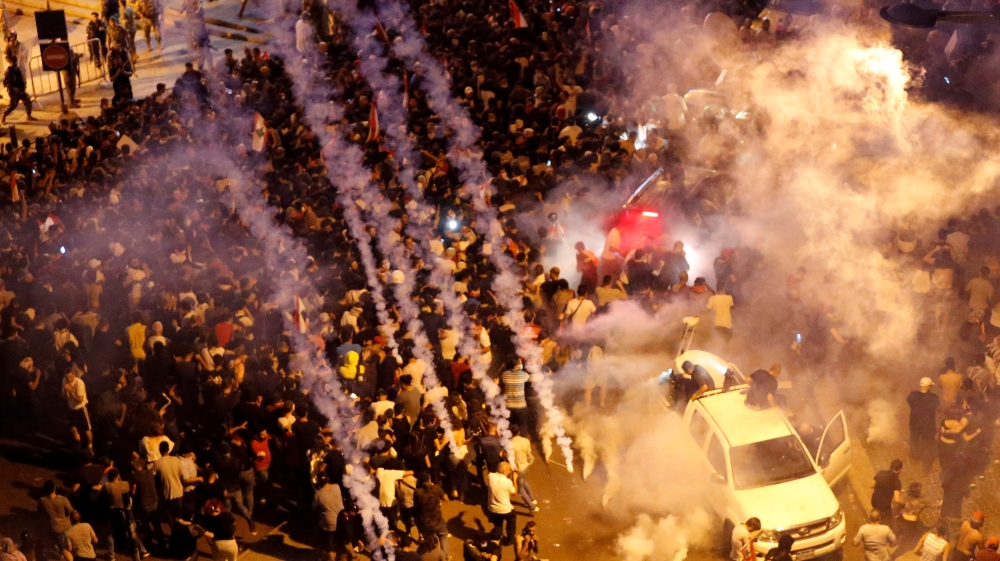 Riot police fire tear gas to disperse demonstrators during a protest targeting the government over an economic crisis, near the government palace in Beirut