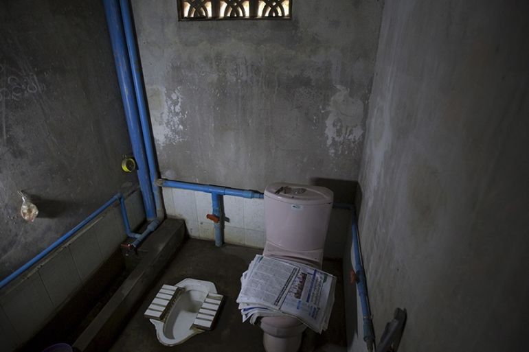Newspapers lie on a toilet seat in a house in Mandalay, Myanmar, October 5, 2015