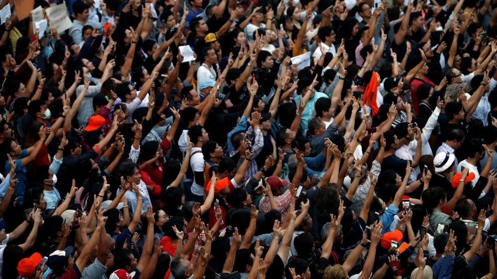 Supporters wave their hands during an unauthorised flash mob rally by the progressive Future Forward Party in Bangkok
