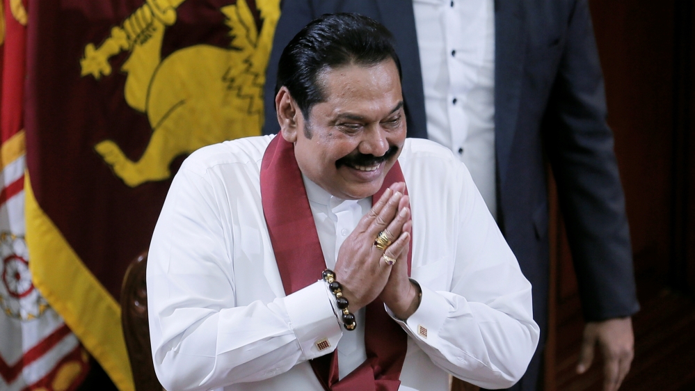 Sri Lanka's former leader Mahinda Rajapaksa, who was appointed as the new Prime Minister, gestures during the swearing in ceremony in Colombo