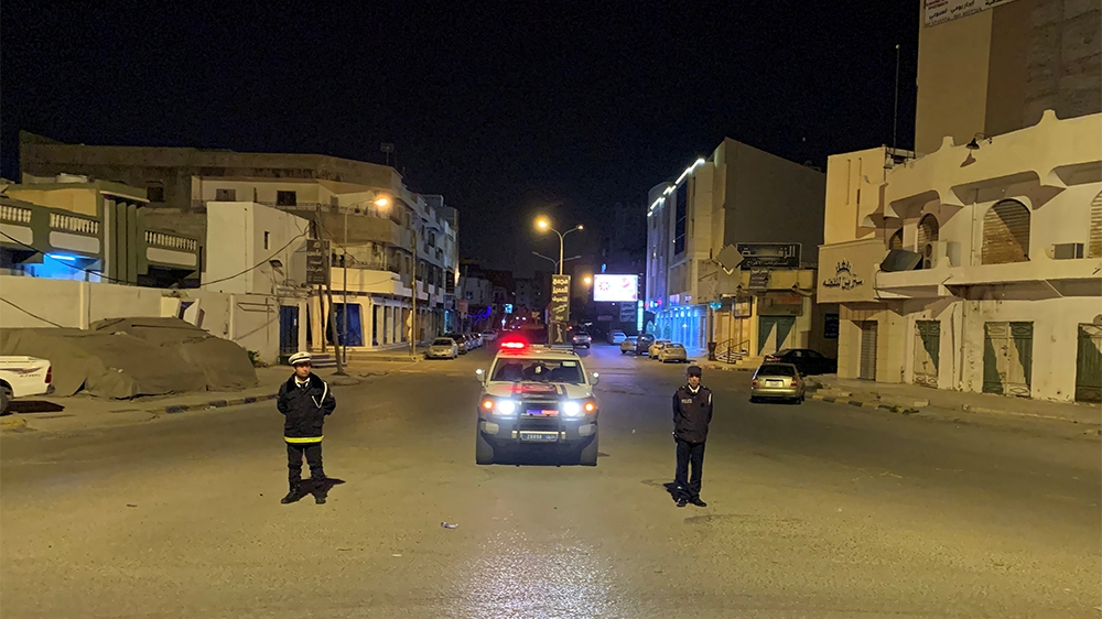 Police officers stand in the middle of the road during a curfew, imposed as part of precautionary measures against coronavirus disease (COVID-19), in Misrata, Libya March 22, 2020. Picture taken March