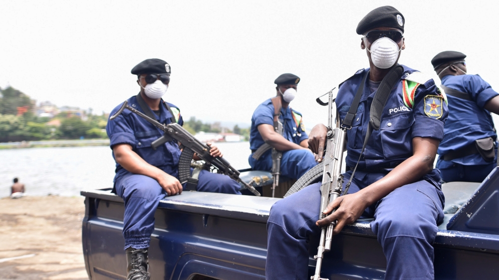 Congolese policemen wear masks as they ride on their patrol pick-up truck amid the coronavirus disease (COVID-19) outbreak in Goma