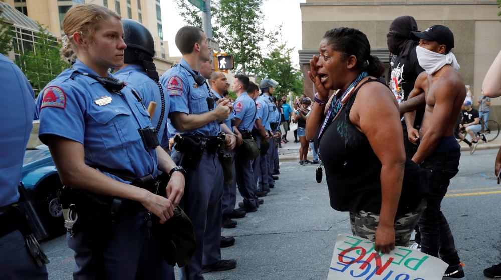 A weeping protester confronts police during nationwide unrest following the death in Minneapolis police custody of George Floyd, in Raleigh, North Carolina, U.S. May 30, 2020. Picture taken May 30, 20