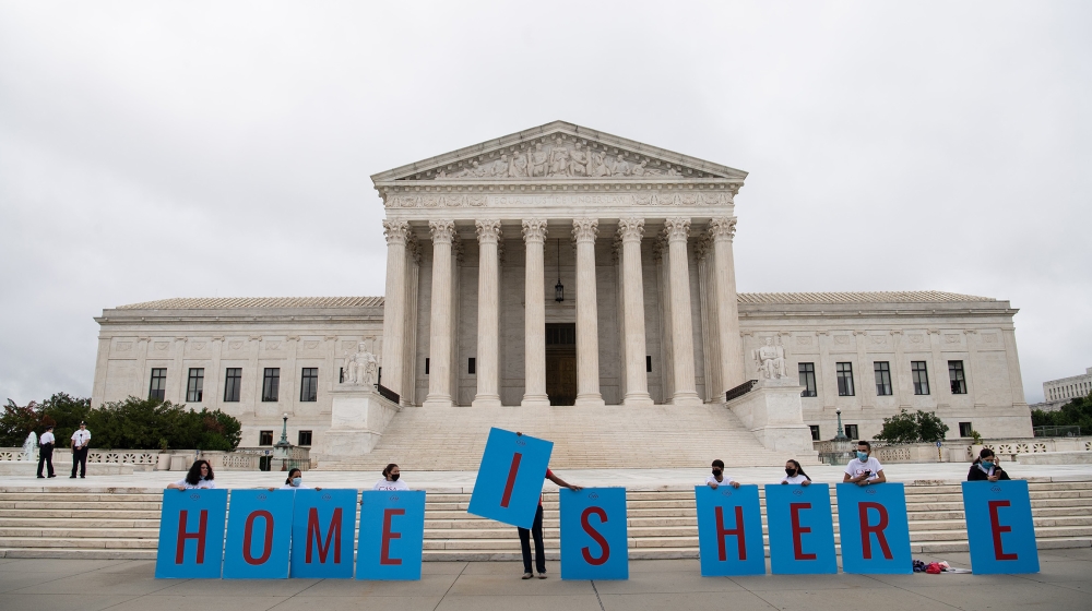 Activists hold a banner in front of the US Supreme Court in Washington, DC, on June 18, 2020. The US Supreme Court rejected President Donald Trump's move to rescind the DACA program that offers protec