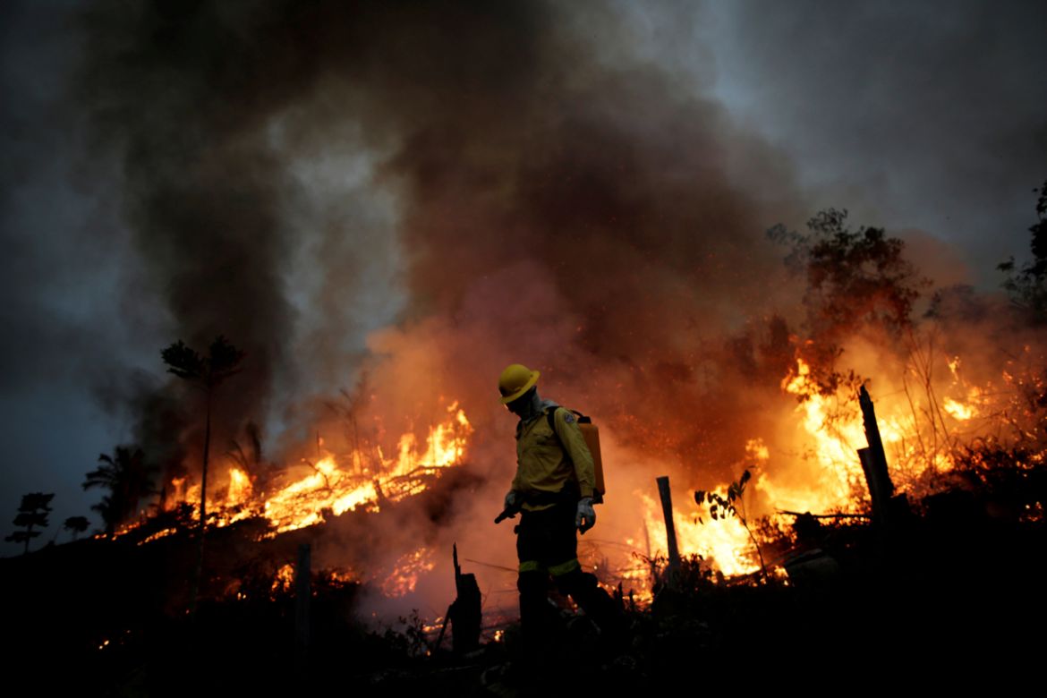 A Brazilian Institute for the Environment and Renewable Natural Resources (IBAMA) fire brigade member attempts to control a fire in a tract of the Amazon jungle in Apui, Amazonas State, Brazil, August