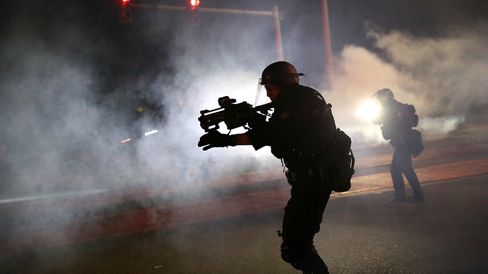 Portland Police officers disperse a crowd of protesters after a Molotov cocktail was thrown on the 100th consecutive night of protests in Portland, Oregon, U.S. September 6, 2020. REUTERS/Caitlin Ochs
