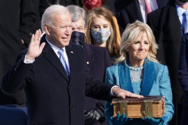 Joe Biden is sworn in as the 46th President of the United States as his wife Jill Biden holds a bible [Kevin Lamarque/Reuters]