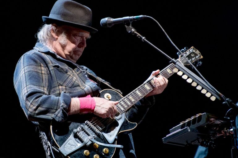 Neil Young performs at stage