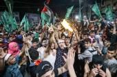 Palestinians celebrate the ceasefire brokered by Egypt between Israel and Hamas in Gaza City [Mahmud Hams/AFP]