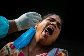 A woman reacts as a heath worker takes her mouth swab sample to test for COVID-19 in Gauhati, India, Friday, May 21, 2021 (AP Photo/Anupam Nath) (AP Photo)