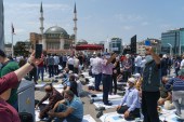 People taking selfies before the first Friday prayers in front of the Taksim Square mosque [Emre Caylak/Al Jazeera]