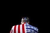 A member of the audience looks on wearing a United States-Israel themed custom suit during the AIPAC convention at the Washington Convention Center in Washington, US, March 2, 2020. [Tom Brenner/Reuters]