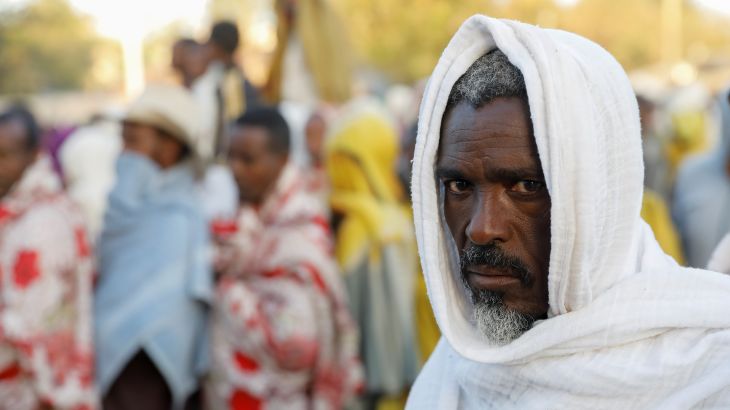 A man stands in line to receive food donations, at the Tsehaye primary school, which was turned into a temporary shelter for people displaced by conflict, in the town of Shire, Tigray region, Ethiopia, March 15, 2021.
