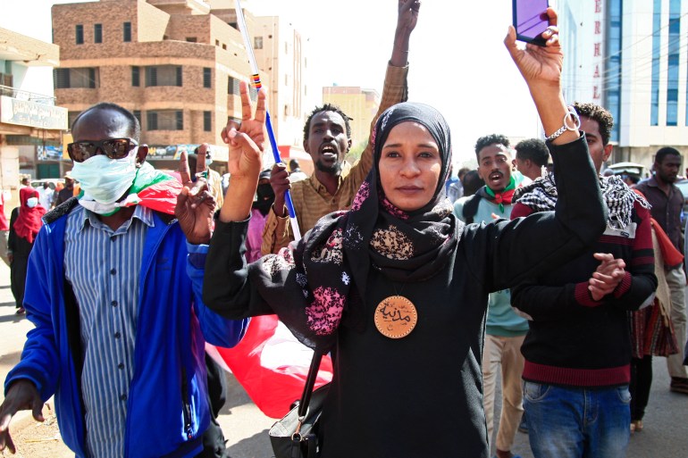 Sudanese are seen during arally against a military coup which occurred nearly three months ago, south of the capital Khartoum, on January 17, 2022. 