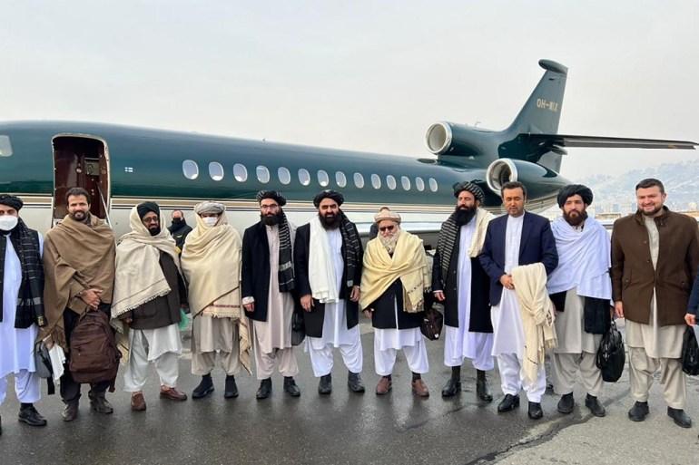 Taliban officials pose in front of an airplane in Norway