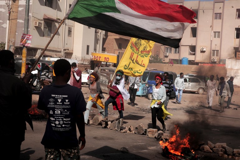 People burn tyres and chant slogans during a demonstration in Sudan