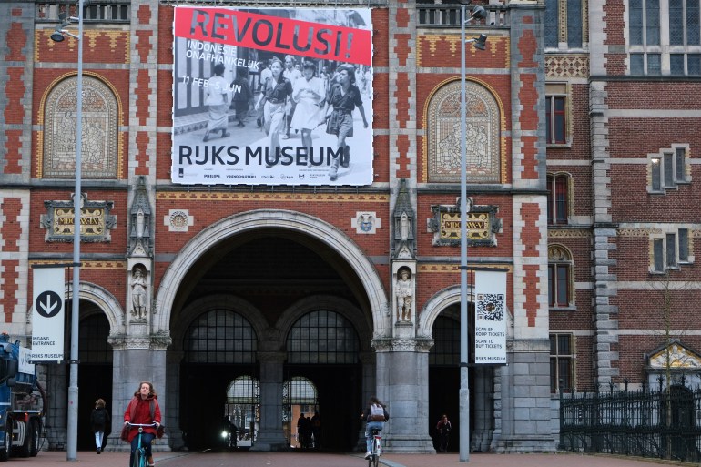 A banner advertising the exhibition on Indonesian independence hangs outside the red brick facade of the Rijksmuseum in Amsterdam