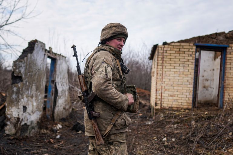 A Ukrainian serviceman stands at his position at the line of separation between Ukraine-held territory and rebel-held territory near Svitlodarsk