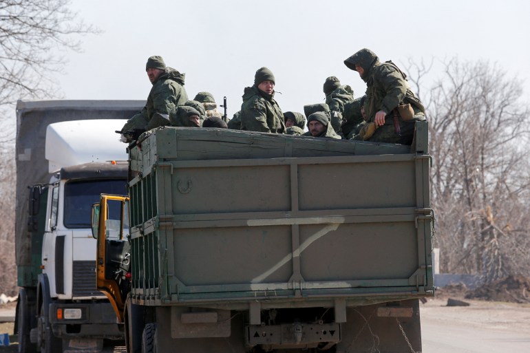 Service members of pro-Russian troops are seen in Mariupol