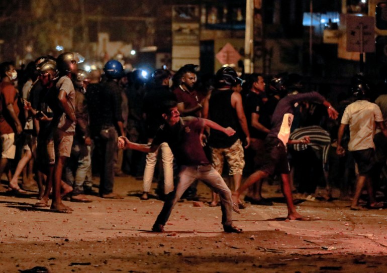 A demonstrator throws a stone near Sri Lankan President Gotabaya Rajapaksa's residence 