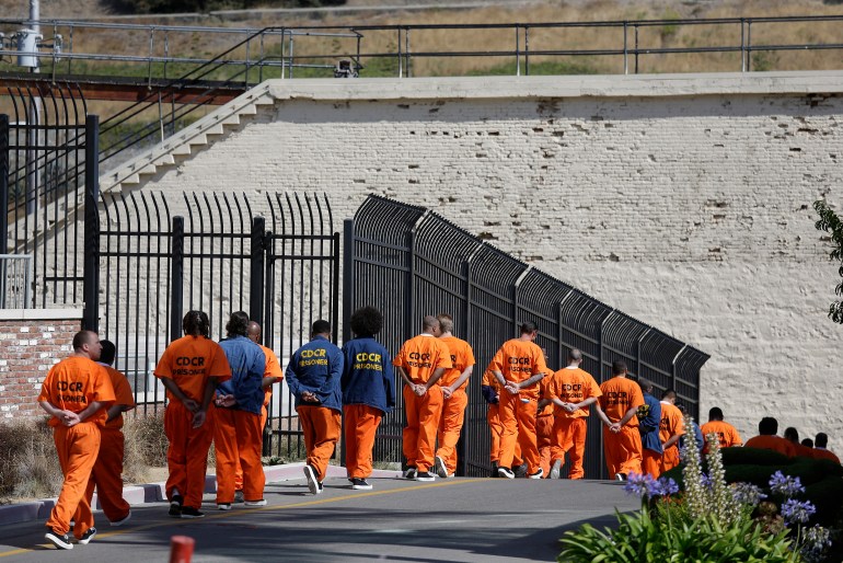 A photo of inmates walking in a line at San Quentin State Prison.
