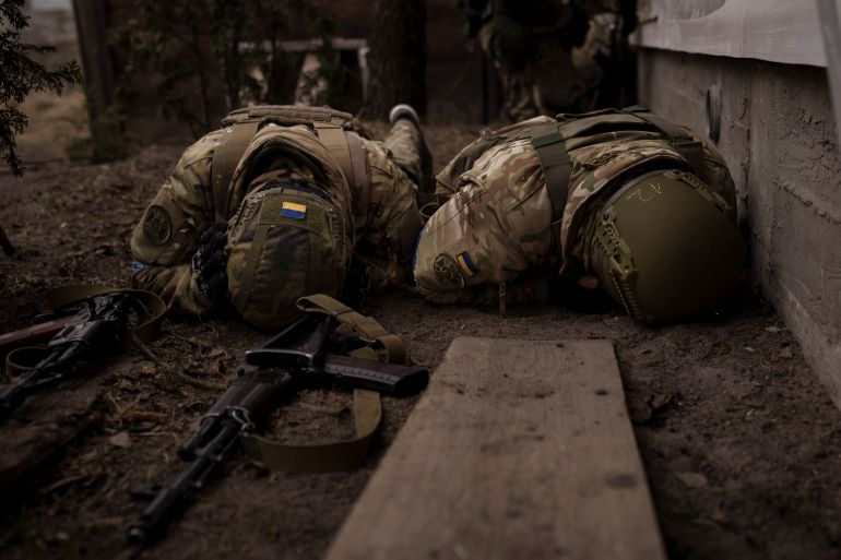 Ukrainian soldiers take cover
