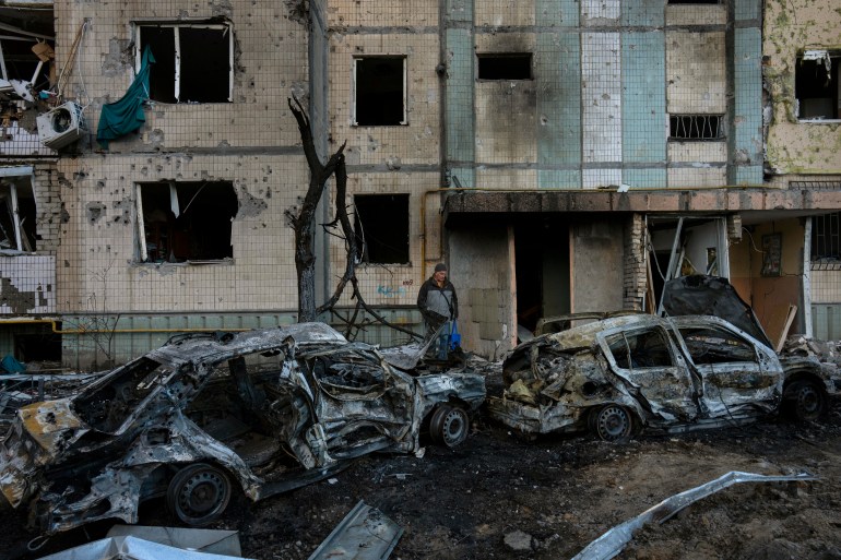 A man stands amid the destruction caused by a bomb in Satoya neighbourhood in Kyiv, Ukraine