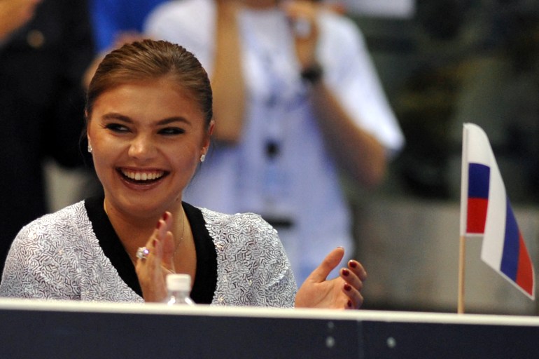 Russian former gymnast Alina Kabaeva smiles as she watches a competition in Turin in Turin in 2008 