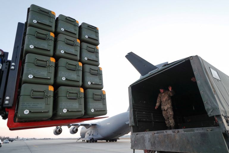 Military aid is seen being unloaded at an airport in Kyiv
