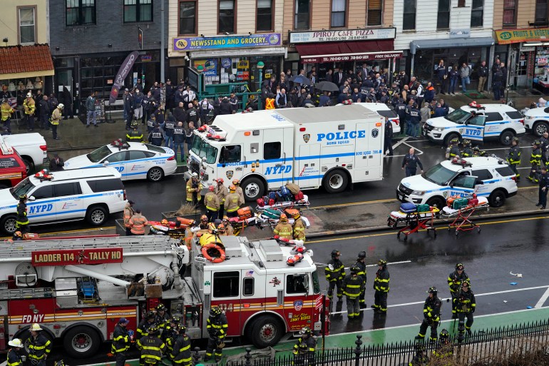 Emergency personnel gather at the entrance to a subway stop in the Brooklyn 