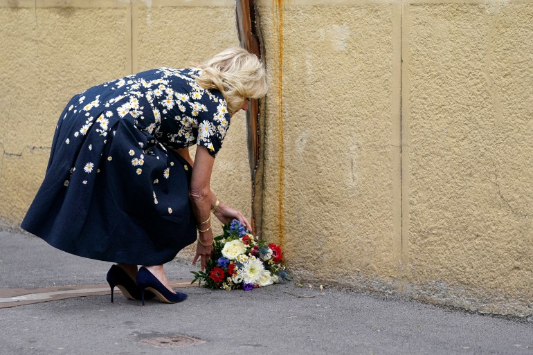 U.S. first lady Jill Biden places flowers at a memorial dedicated to the 26-year-old investigative journalist Jan Kuciak and his fiancée Martina Kusnirova, assassinated in their home in 2018