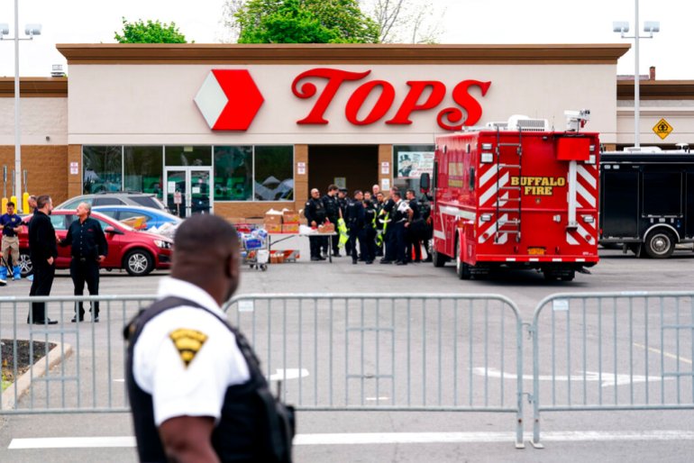 Investigators work the scene of a shooting at a Tops supermarket, in Buffalo.