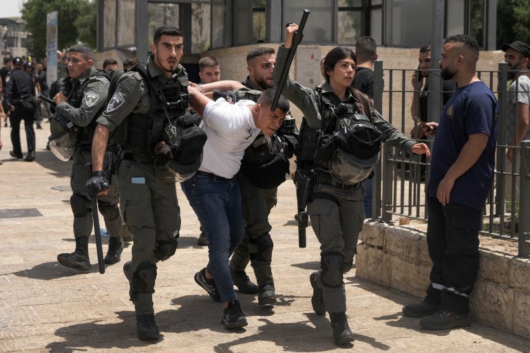 Members of Israeli security forces detain a Palestinian protester near Damascus Gate outside Jerusalem's Old City.